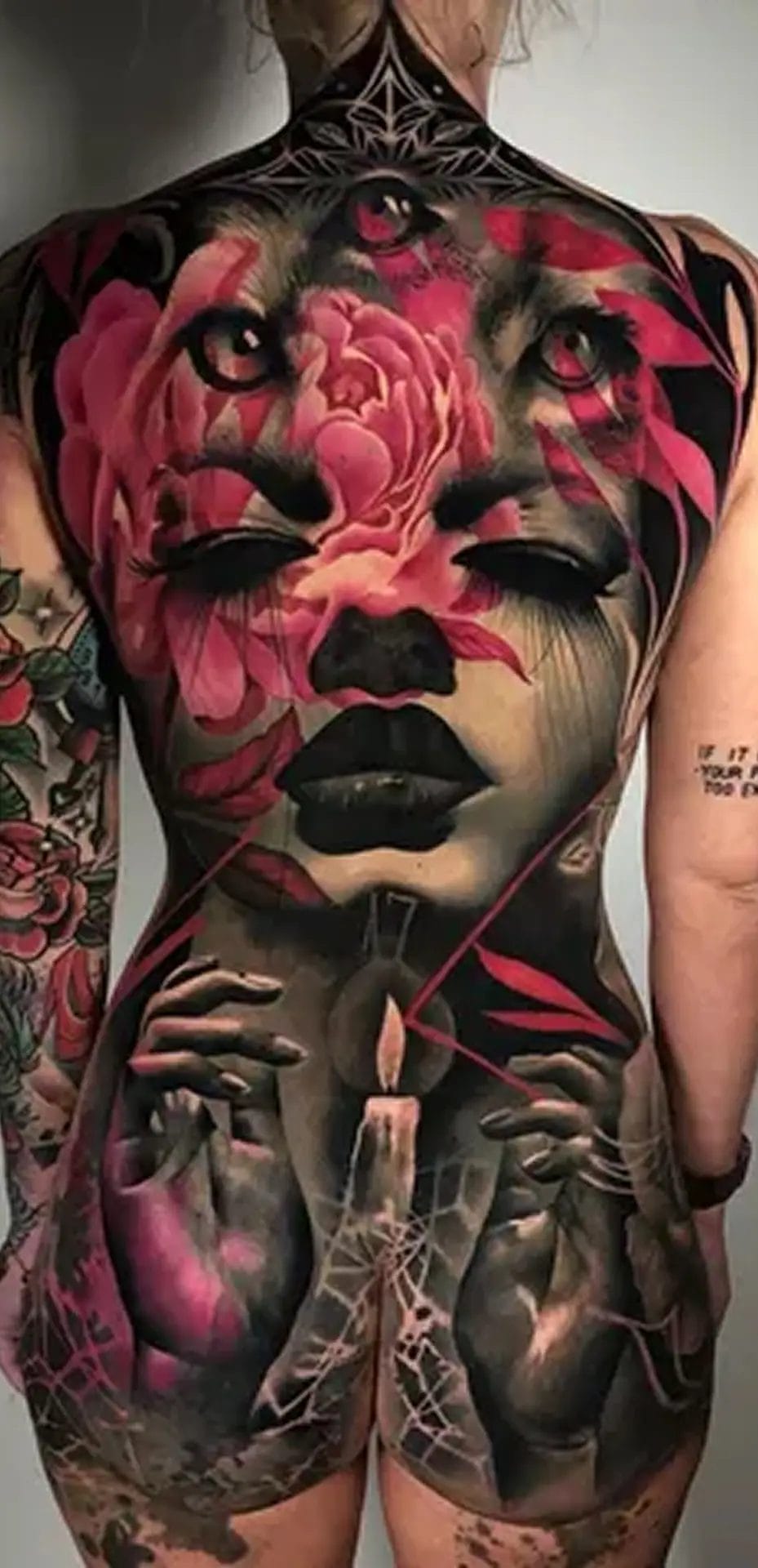 Image of female body backside covered with large tattoo.